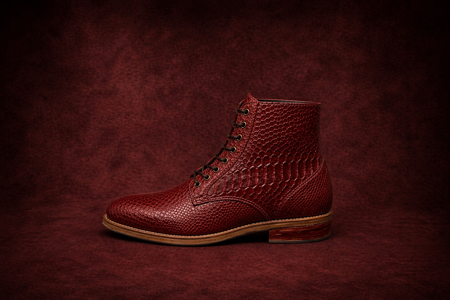 Red leather boot on a dark red textured background FOSSIL Dragon Blood Oxblood Red Lace-Up Leather Dress Boot for Men - Kyoto Boots