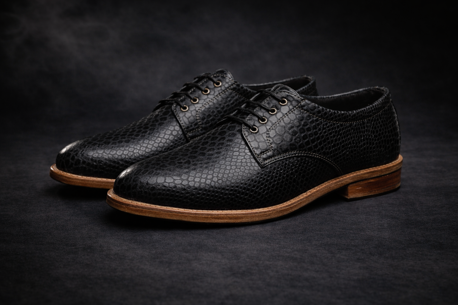 Black leather shoes with brown soles on a dark background FOSSIL Dendroaspis Black Textured Leather Derby Shoes for Men - Kyoto Boots