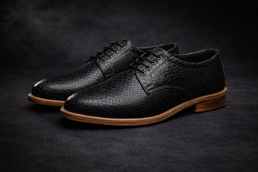 Black leather shoes with brown soles on a dark background FOSSIL Dendroaspis Black Textured Leather Derby Shoes for Men - Kyoto Boots