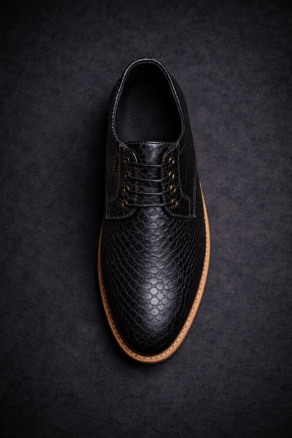 Black leather shoe with brown soles on a dark textured background FOSSIL Dendroaspis Black Textured Leather Derby Shoes for Men - Kyoto Boots